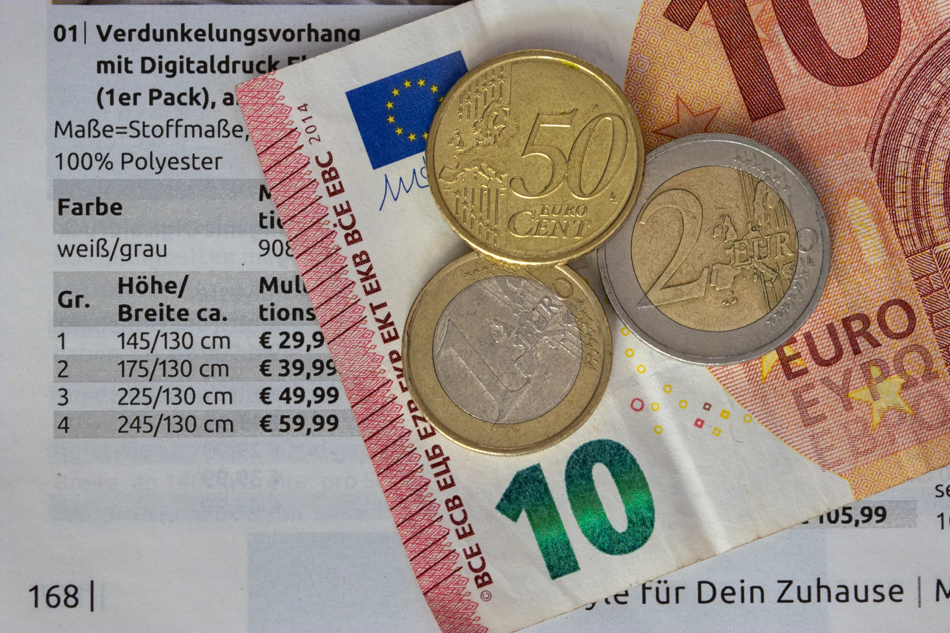 Euro coins beside a travel notebook.