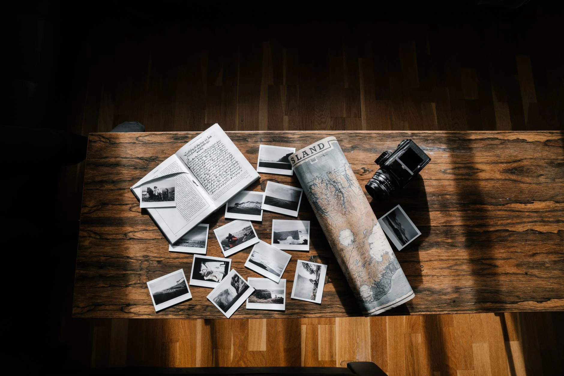 A traveler consults a map and takes notes before planning a trip.